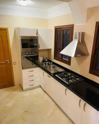 a kitchen with a sink and a stove at Appartement Résidence de standing Hivernage in Marrakech