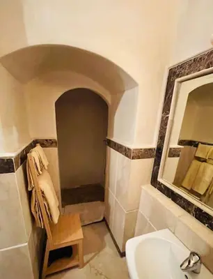 a bathroom with a sink and a toilet and a mirror at Appartement Résidence de standing Hivernage in Marrakech