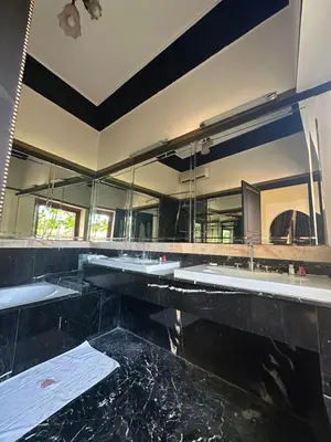 a bathroom with three sinks and a large mirror at Palais FARAH in Marrakech