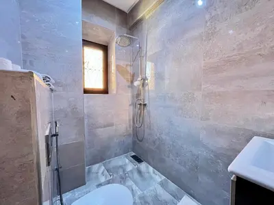 a bathroom with a shower and a toilet and a sink at Villa Al Nour avec piscine in Marrakech