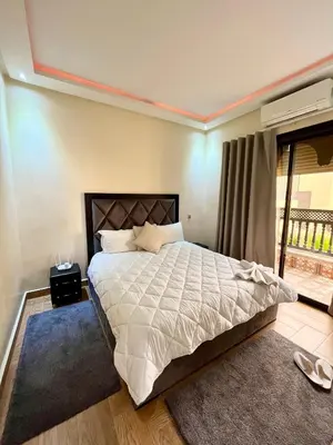 a bedroom with a large bed and a balcony at Villa Al Nour avec piscine in Marrakech