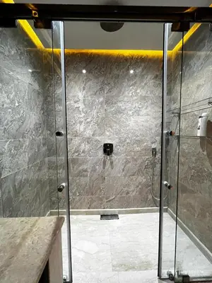 a shower with a glass door in a bathroom at Villa Al Nour avec piscine in Marrakech