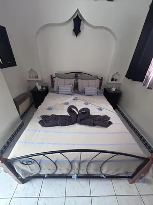 a bedroom with a bed with two slippers on it at Riad le pélican in Marrakech