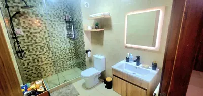 a bathroom with a shower and a toilet and a sink at Super appartement haut standing ensoleillé gare in Marrakech