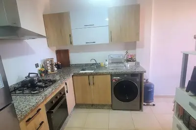 a kitchen with a sink and a washing machine at Super appartement haut standing centre gare in Marrakech