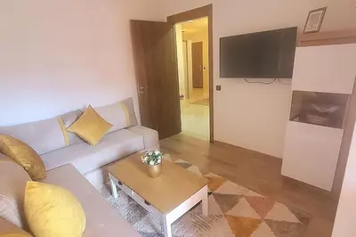a living room with a couch and a table at Super appartement haut standing centre gare in Marrakech