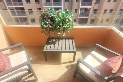 a balcony with a bench and a potted plant at Super appartement haut standing centre gare in Marrakech