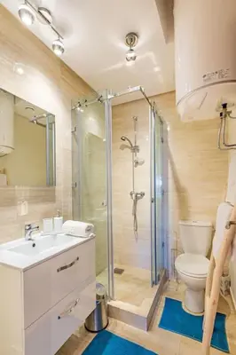 a bathroom with a shower and a toilet and a sink at Golf Prestigia, grande piscine, jardins in Marrakech