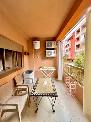 a balcony with a table and chairs and a window at Cosy luxe RB Marrakech in Marrakech