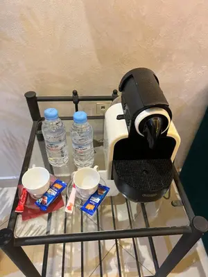 a coffee maker and two bottles of water on a rack at Cosy luxe RB Marrakech in Marrakech