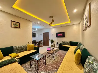 a living room with couches and a table at Cosy luxe RB Marrakech in Marrakech