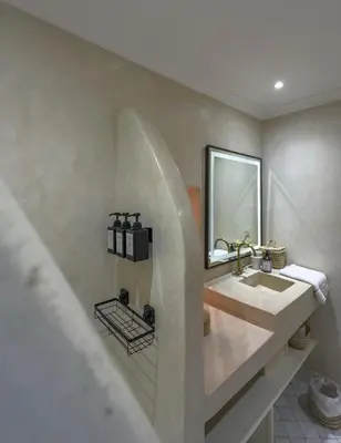 a bathroom with a sink and a mirror at Riad & SPA Privé - La Perle d'Orane - Marrakech in Marrakech