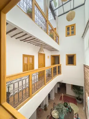an open hallway with a balcony with wooden railings at Riad & SPA Privé - La Perle d'Orane - Marrakech in Marrakech