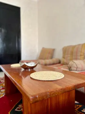 a wooden coffee table in a living room with a couch at Cozy Apartment In Marrakech in Marrakech