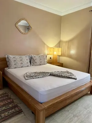 a bedroom with a large bed with white sheets and pillows at Cozy Apartment In Marrakech in Marrakech