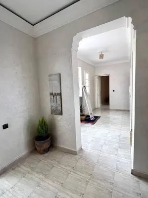a living room with a tile floor and a hallway at Cozy Apartment In Marrakech in Marrakech