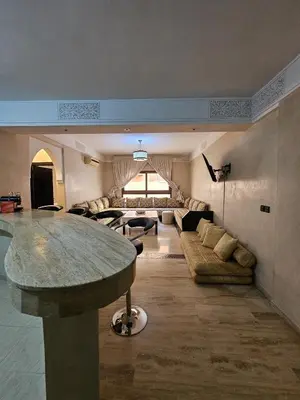a large living room with a large marble table at APPARTEMENT DOUILLET AU CENTRE GUELIZ in Marrakech