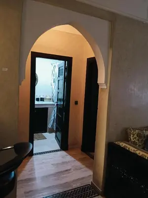 an archway leading to a hallway with a door to a room at APPARTEMENT DOUILLET AU CENTRE GUELIZ in Marrakech