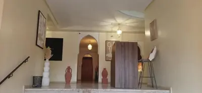 a hallway with vases and a door in a building at APPARTEMENT DOUILLET AU CENTRE GUELIZ in Marrakech