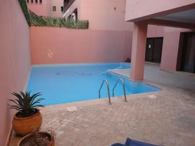 a swimming pool in the middle of a building at APPARTEMENT DOUILLET AU CENTRE GUELIZ in Marrakech