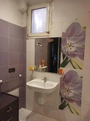 a bathroom with a sink and a mirror with flowers on the wall at Villa Mima in Marrakech