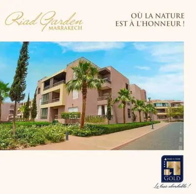 a picture of a building with palm trees next to a street at Appartement Luxe Riad Garden Marrakech 3 piscines in Marrakech