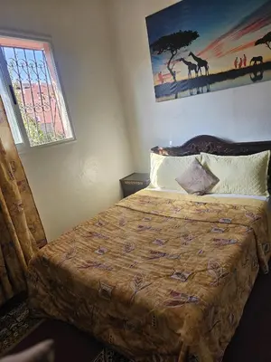 a bedroom with a bed and a painting on the wall at Marrakech plus in Marrakech