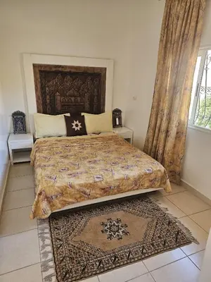 a bedroom with a large bed and a window at Marrakech plus in Marrakech