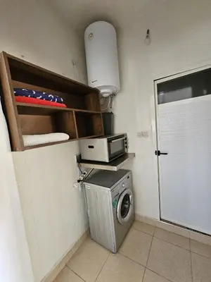 a kitchen with a washing machine and a microwave at Marrakech plus in Marrakech