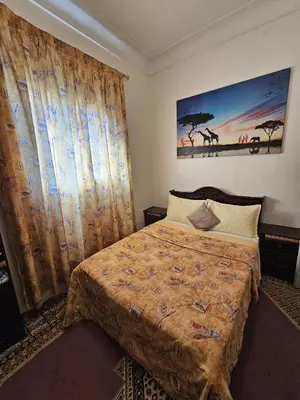 a bedroom with a bed and a painting on the wall at Marrakech plus in Marrakech