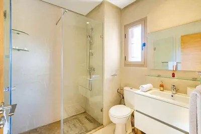 a bathroom with a shower and a toilet and a sink at Prestigia Saphir,Piscine, Jardin in Marrakech