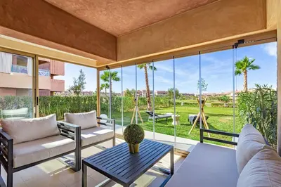 a living room with a couch and a table at Prestigia Saphir,Piscine, Jardin in Marrakech