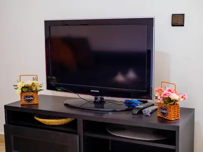 a flat screen tv sitting on top of a table at Family Illuminated Apartment With Pool in Marrakech