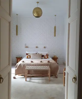 a bedroom with a bed and a table in it at Riad Fisaline en exclusivité pour vous à Marrakech in Marrakech