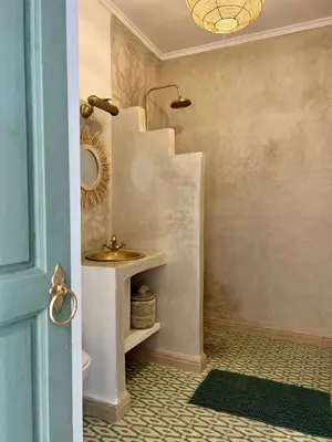 a bathroom with a sink next to a staircase at Riad Fisaline en exclusivité pour vous à Marrakech in Marrakech