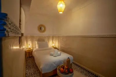 a bedroom with a bed and a basket of shoes at Riad Tarba & Spa in Marrakech