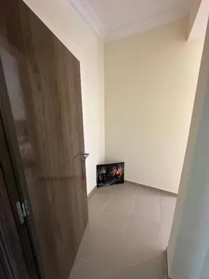 an empty room with a door and a painting on the wall at Marrakech airport apartment in Marrakech