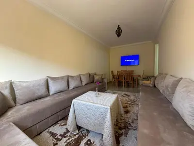 a living room with a couch and a table at Marrakech airport apartment in Marrakech