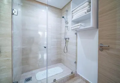 a bathroom with a shower with a glass door at Central & comfy 3BR apartment with pool & wifi access in Marrakech