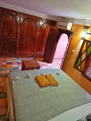 a bedroom with a bed with two towels on it at Medina house in Marrakech