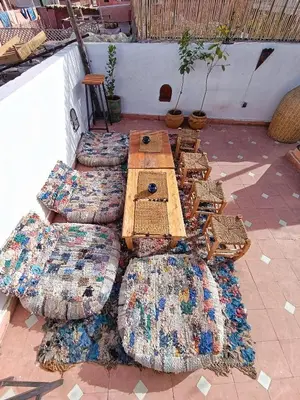 a group of pillows and tables on a patio at Medina house in Marrakech
