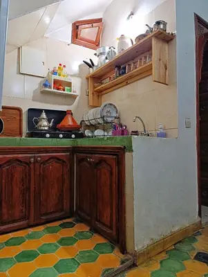 a kitchen with wooden cabinets and a counter top at Medina house in Marrakech