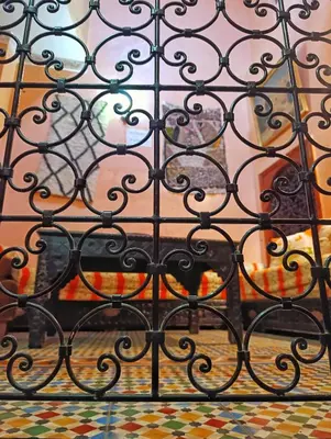 a black iron gate with a window behind it at Medina house in Marrakech