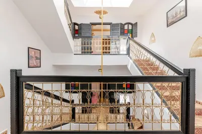 a staircase in a house with a glass railing at 16 Riads in Marrakech