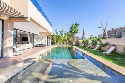 a swimming pool in the backyard of a house at Villa Rafinity Marrakech in Marrakech