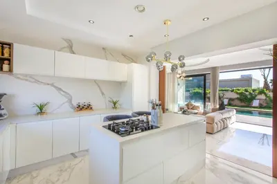 a kitchen with white cabinets and a stove at Villa Rafinity Marrakech in Marrakech