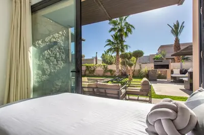 a bedroom with a bed and a view of a patio at Villa Rafinity Marrakech in Marrakech