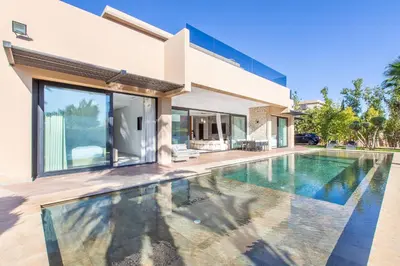 a swimming pool in front of a house at Palais Rafi in Marrakech