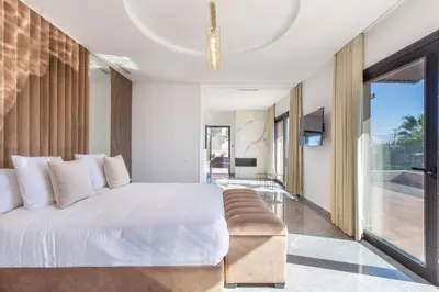 a bedroom with a white bed and a couch at Palais Rafi in Marrakech