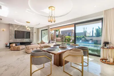 a living room with a table and chairs at Palais Rafi in Marrakech
